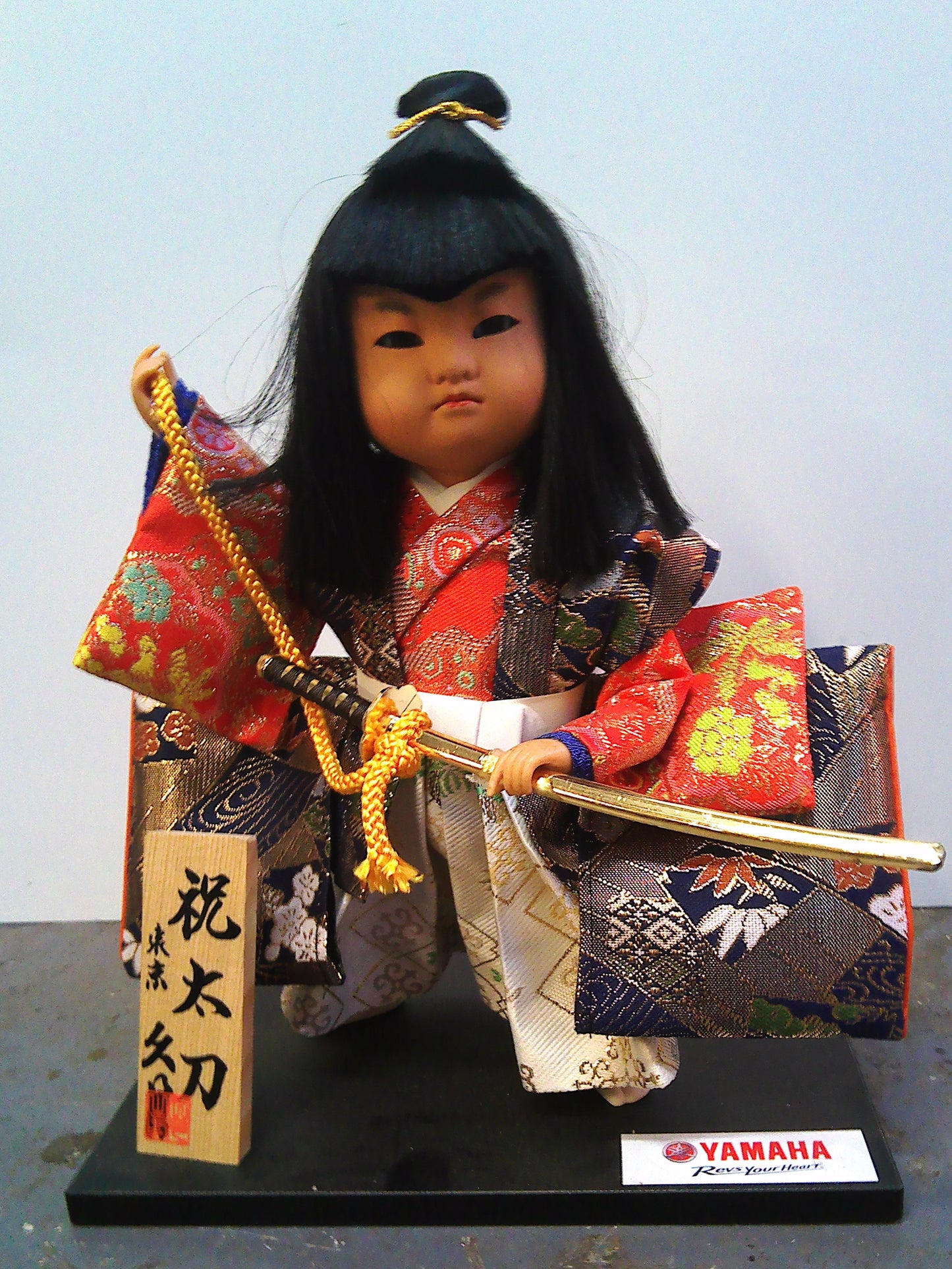Yamaha Kyugetsu doll with Christmas 1994 framed tapestry