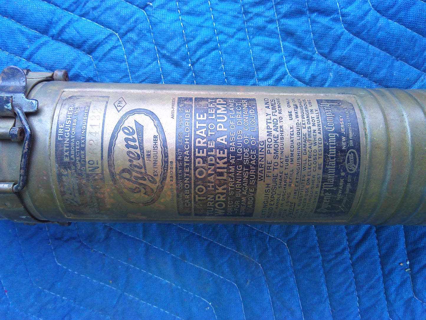 Late 19th Century Vintage Pyrene fire extinguisher with wall holder