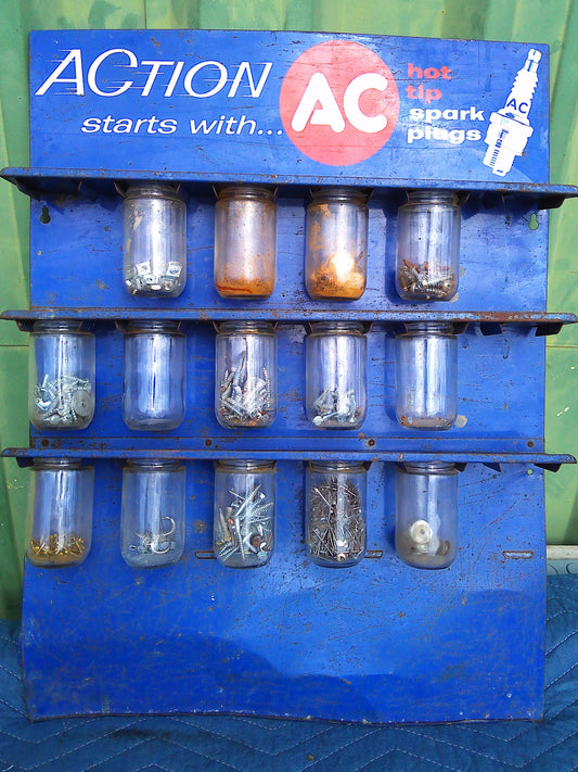 1950sAction starts with AC spark plug jar rack