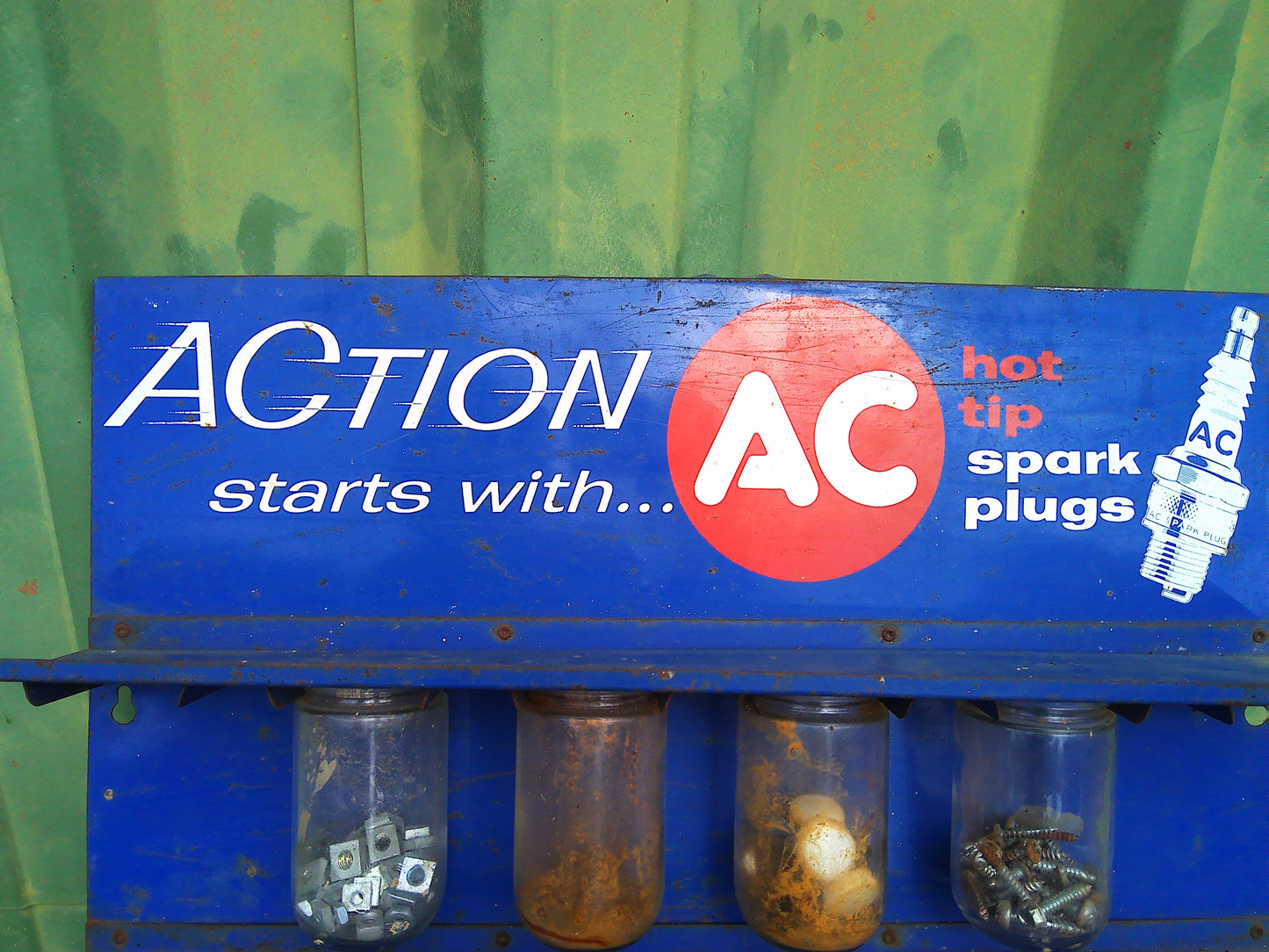 1950sAction starts with AC spark plug jar rack