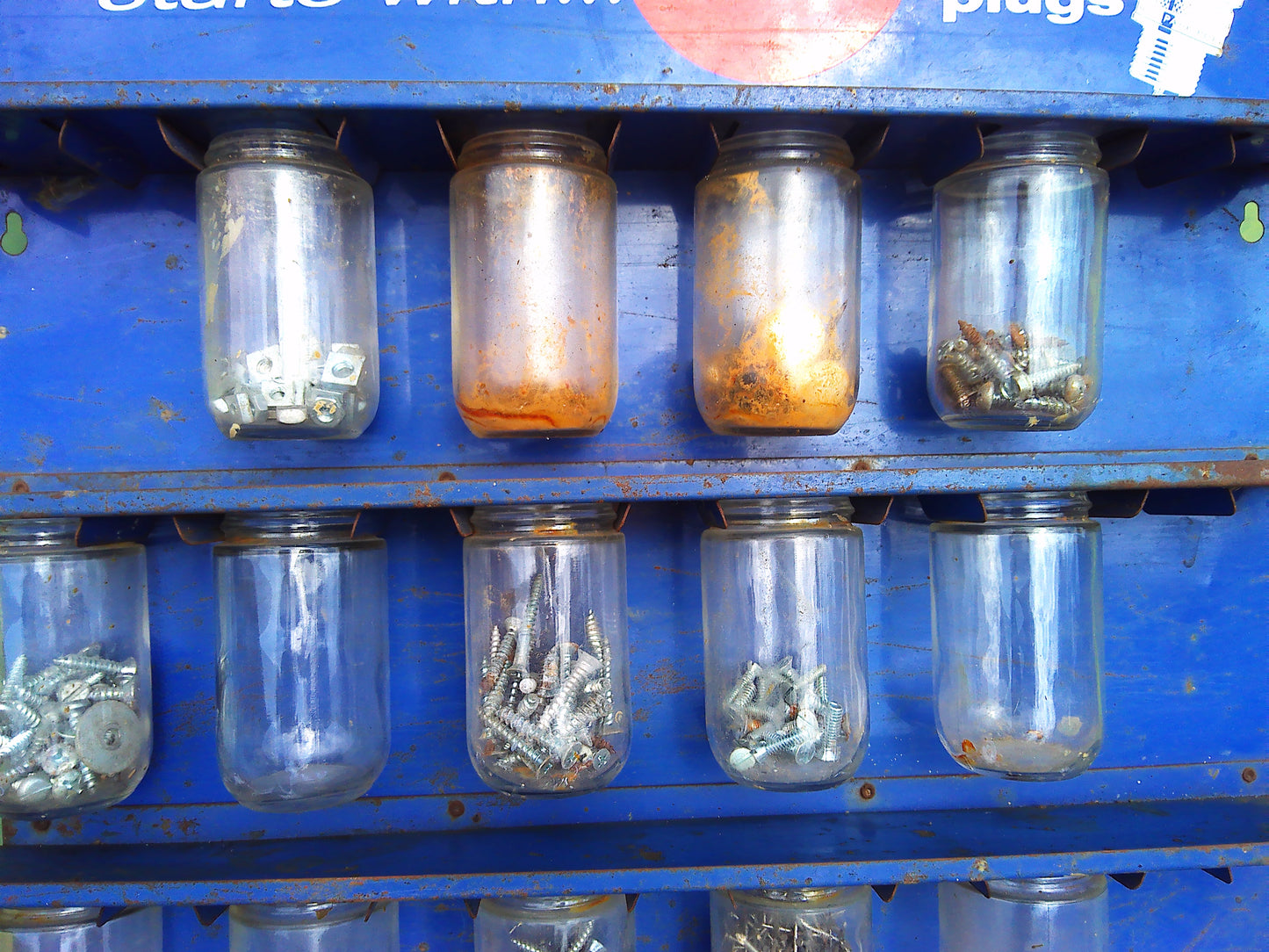 1950sAction starts with AC spark plug jar rack