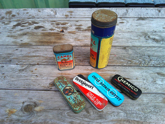 Assortment of vintage bicycle tyre repair kits